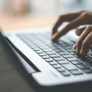 Hand typing on a keyboard